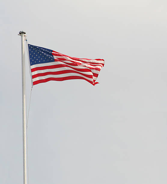 istock American Flag Waving Overcast Sky 464781651