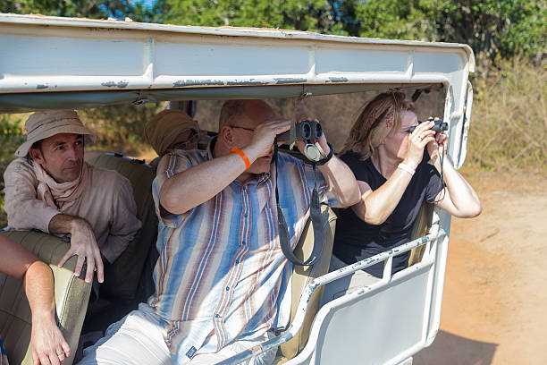 Yala National Park, Sri Lanka - March 4, 2014: Tourists looking through binoculars during safari tour in the Yala park. Yala is the second largest national park in Sri Lanka.
