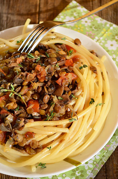 Pasta with lentil bolognese Pasta with lentil bolognese on the white plate with the fork spicery stock pictures, royalty-free photos & images