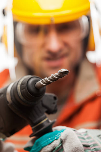 istock Engineer or manual worker man holding electric hammer drill tool 464784736