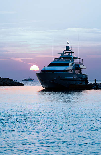 Yacht at Sunset. Marina. Moody Sky. Blue Toned image. stock photo