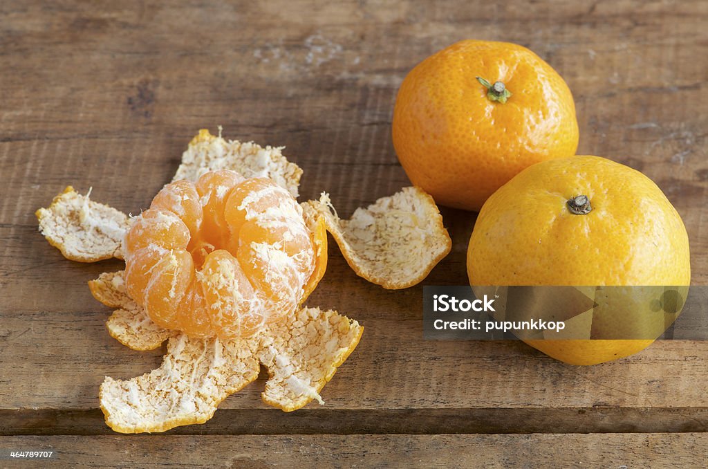 tangerine on wooden table fresh tangerine on wooden table Citrus Fruit Stock Photo