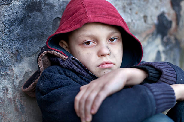 istock homeless boy leaned against the wall 464791369