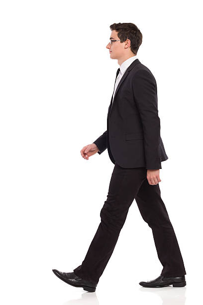 istock Young businessman in black suit walking 464791695