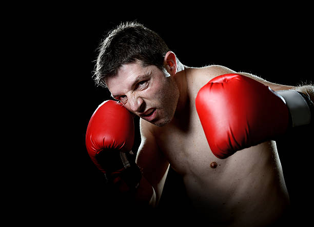istock angry man boxing throwing vicious left hook punch in gym 464793108