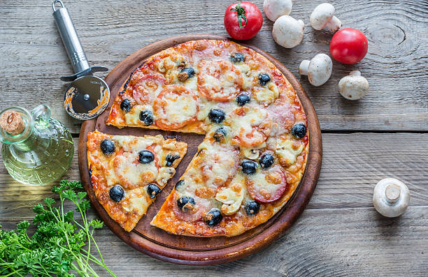 istock Cooked pizza on the wooden board 464797470