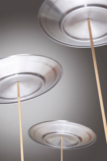 Four silver plated spinning on wooden sticks