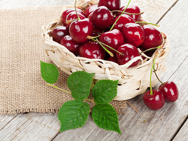 istock Ripe cherries on wooden table 464799128