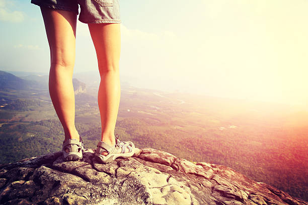 istock hiking woman legs on mountain peak 464799322