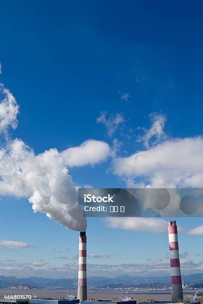 Smokestack And Gas Emissions Against Blue Sky Stock Photo - Download Image Now - 2015, Air Pollution, Blue