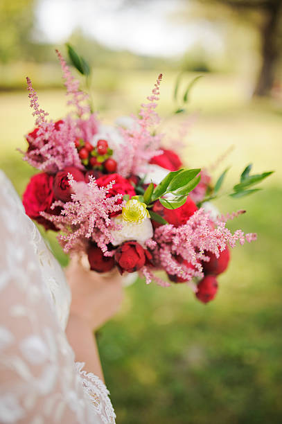 istock Bride holding a bouquet of beautiful roses 464802096