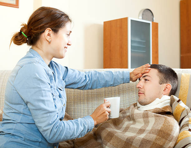 istock woman caring for sick man 464802247