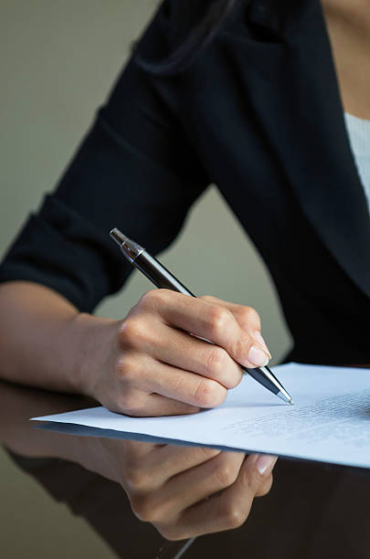 istock woman signing a contract 464802250