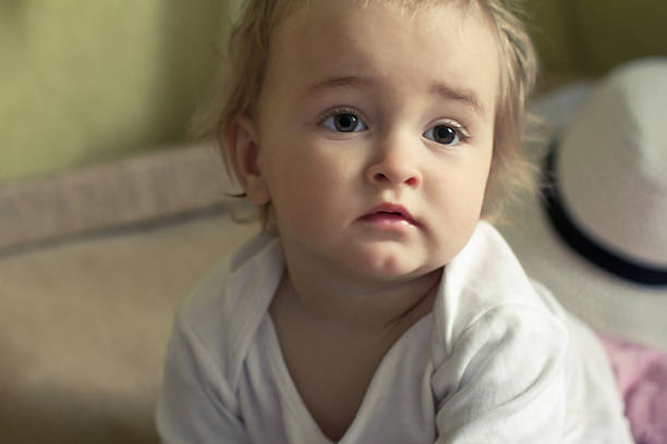 istock thoughtful girl sitting on the bed 464803690