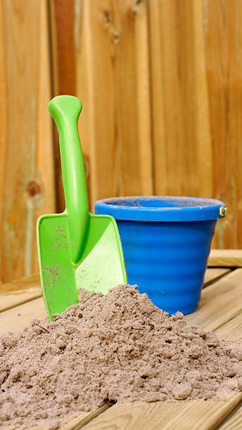 istock Child scoop and sand in the sun 464808078