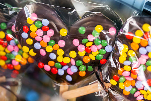 istock Sweets on sticks. Chocolate hearts with colorful candy 464810493