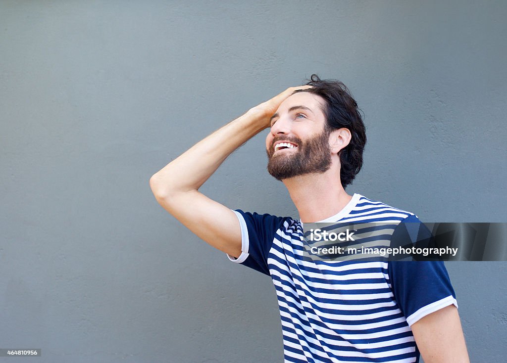 Cool guy smiling with hand in hair Close up portrait of a cool guy smiling with hand in hair 20-29 Years Stock Photo