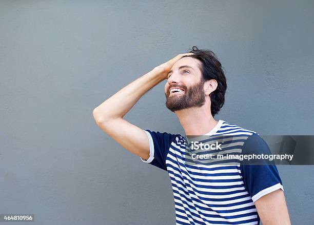 Cool Guy Smiling With Hand In Hair Stock Photo - Download Image Now - 20-29 Years, 2015, Adult