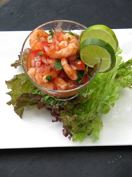 istock Ceviche in a glass cup on a white plate 464813378