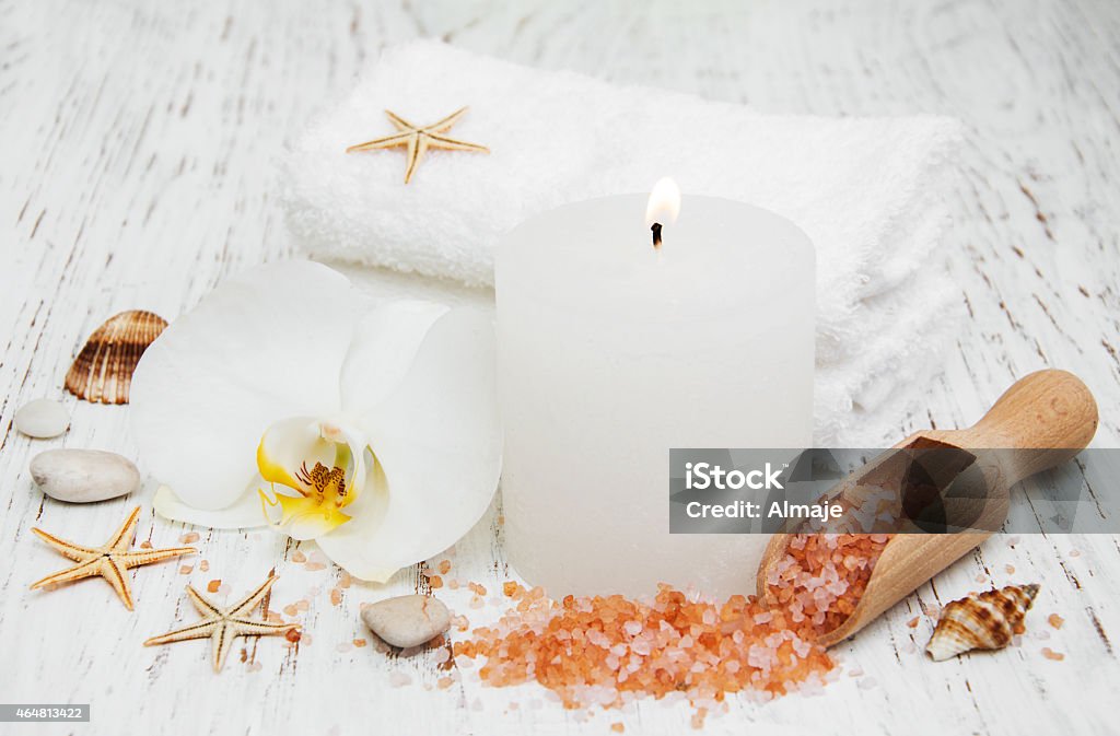 Candle, orcids and towels Candle, orcids and towels on a wooden background 2015 Stock Photo