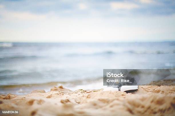 Sneakers On The Beach Stock Photo - Download Image Now - 2015, Baltic Sea, Beach