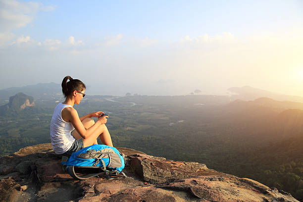 istock hiking woman  use  smart phone on mountain peak 464816950