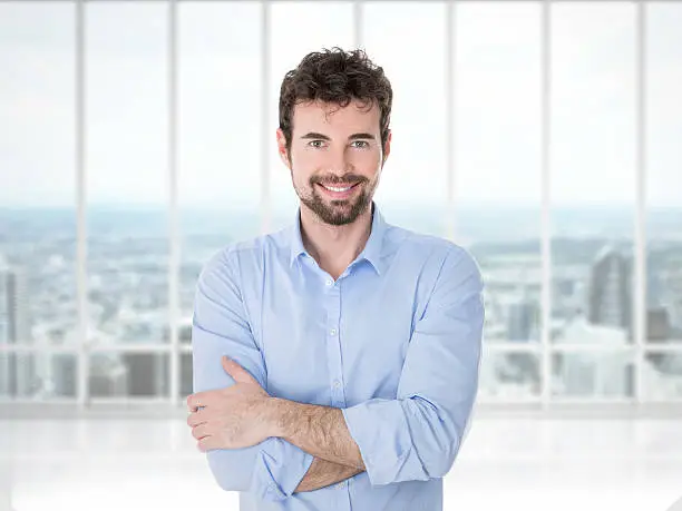 smiling man in career on the last floor of his company