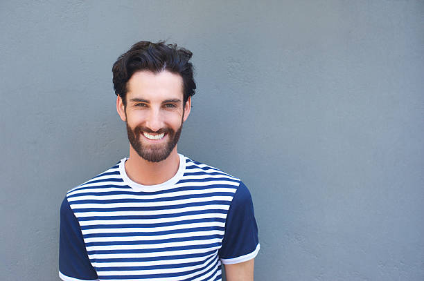 istock Cool young man smiling in striped shirt 464819768