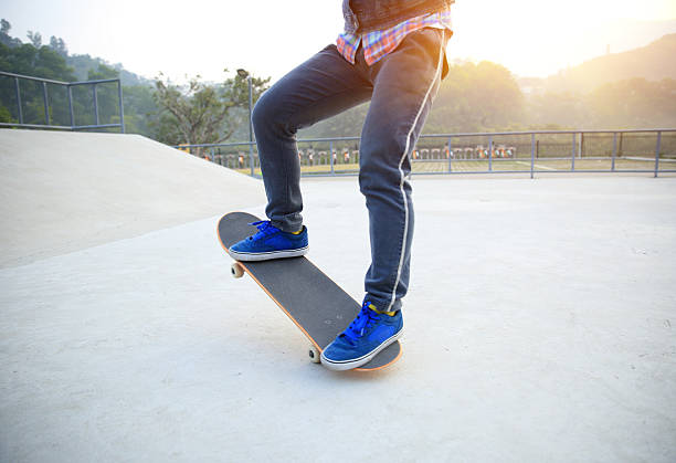 istock skateboarder jump at skatepark 464825410
