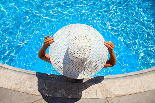 woman relaxing in resort swimming pool