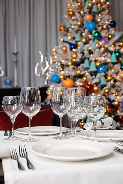istock Wineglasses and Christmas tree in background 464825573