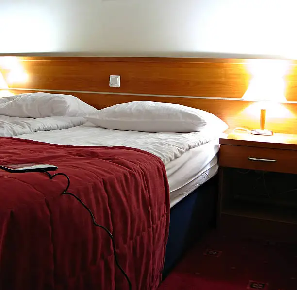 Hotel room showing bed, pillow and lamp