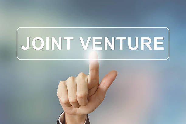 istock business hand clicking joint venture button on blurred backgroun 464830584