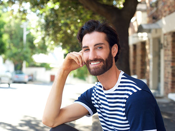 istock Friendly young man smiling outdoors 464830620