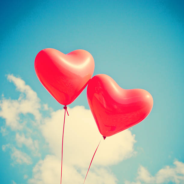 istock Two heart-shaped balloons in the sky 464831197
