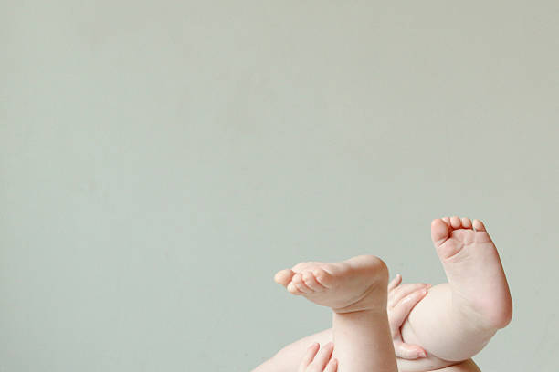 Baby feet and hands in the air.