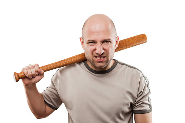 Angry man hand holding baseball sport bat Violence and aggression concept - furious angry man hand holding baseball sport bat skin head stock pictures, royalty-free photos & images