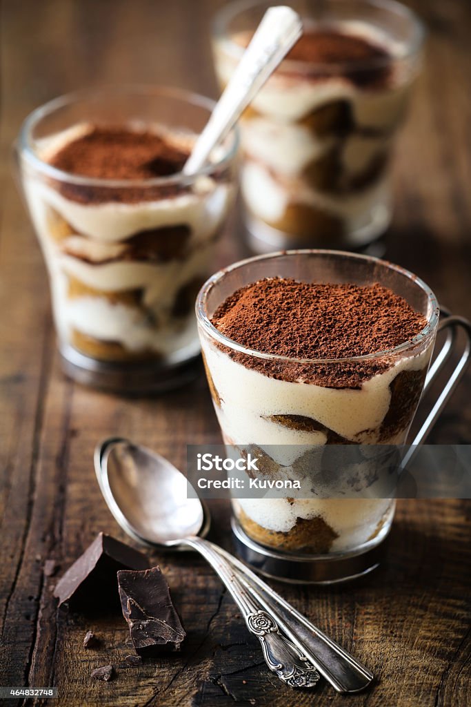 Tiramisu Delicious freshly homemade Italian dessert Tiramisu in glass cups in a rustic wood background Tiramisu Stock Photo