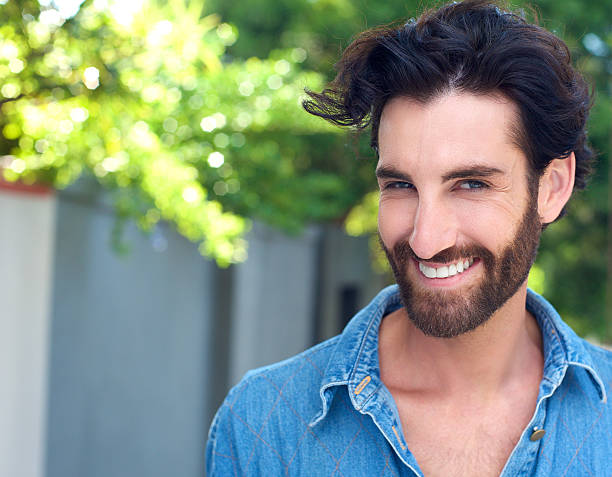 istock Confident young man with beard smiling outdoors 464832894