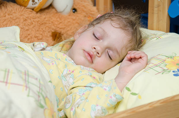 istock Three year old girl sleeping in her crib 464833056
