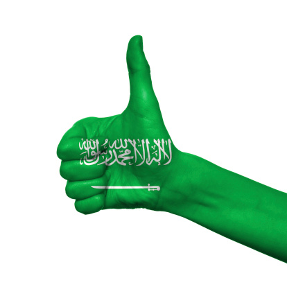 Saudi Arabia flag painted on hand over white background