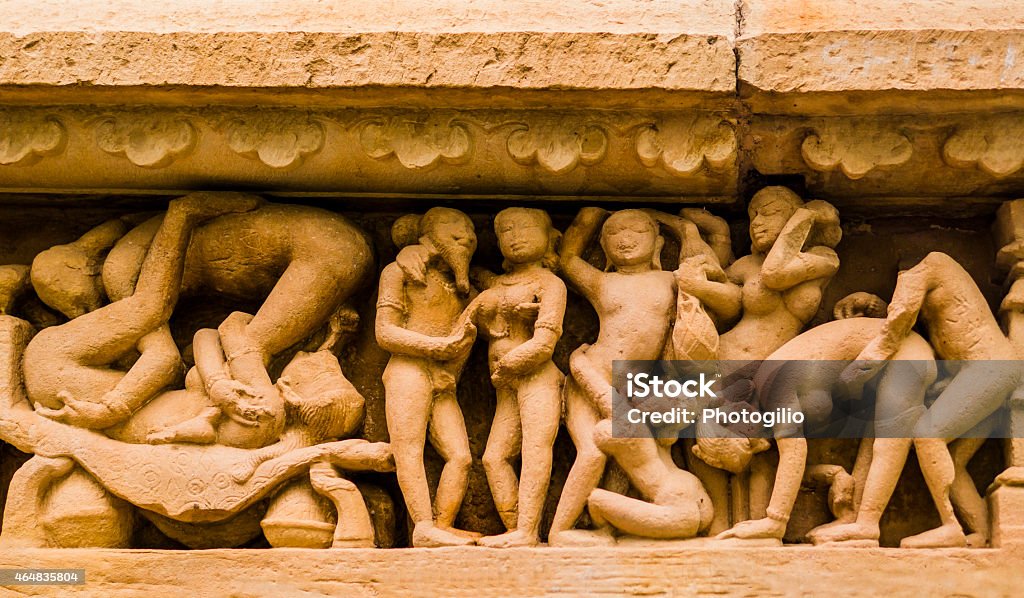 Erotic sculpture in Khajuraho temple, India Stone carved erotic sculpture in Khajuraho temple, India Group Of People Stock Photo