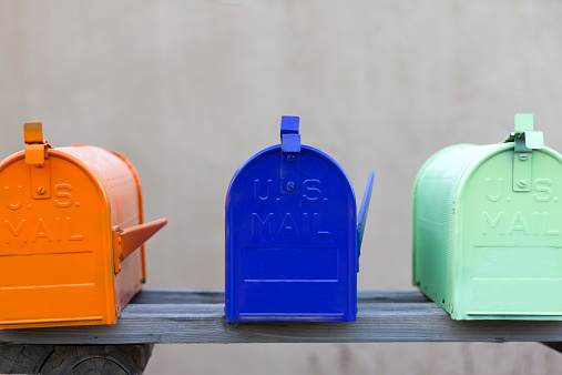 Three colorful mailboxes rural mailboxes. Copy space available at the top of the frame.