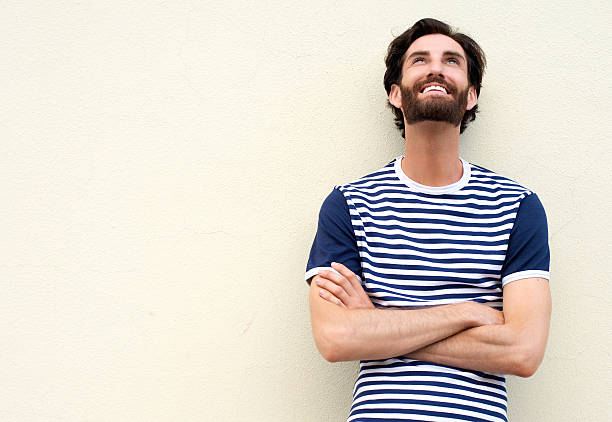 istock Cheerful young man smiling and looking up on white background 464836962