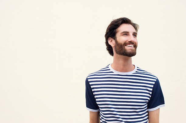 istock Cheerful young man with beard smiling on white background 464837164