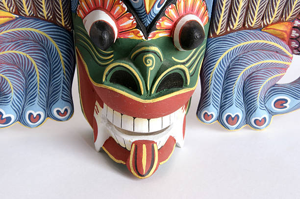 Traditional Indonesian (Balinese) mask-souvenir from a tree isolated on white background