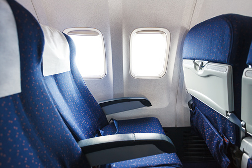 blue seats in economy class passenger section of airplane