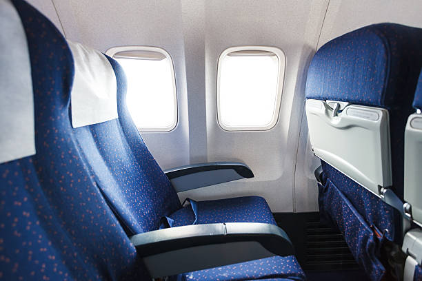 seats in economy class section of airplane blue seats in economy class passenger section of airplane vehicle seat stock pictures, royalty-free photos & images