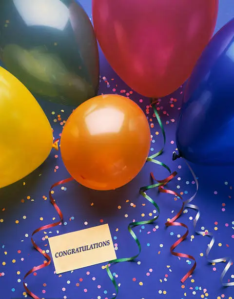 A festive background with balloons and a congratulation card