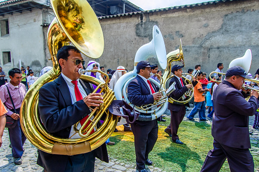 Antigua, Guatemala -  April 1, 2012: Musicians at rear of Palm Sunday procession in Spanish colonial town & UNESCO World Heritage Site with most famous Holy Week celebrations in Latin America.